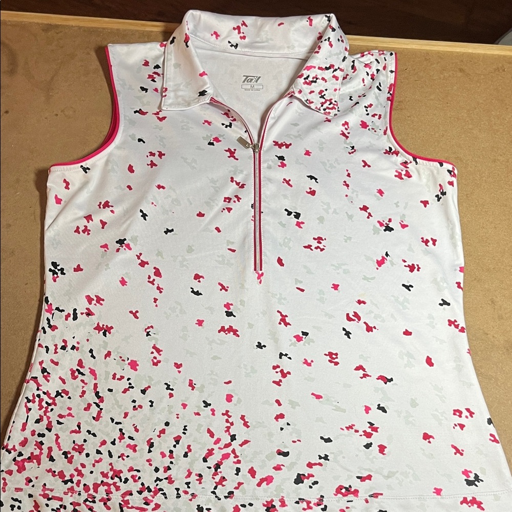 White Sleeveless Tail Zip Polo with Pink and Black Print. Medium.